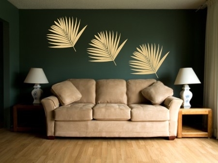 Naklejka dekoracyjny liść palmy na zielonej ścianie